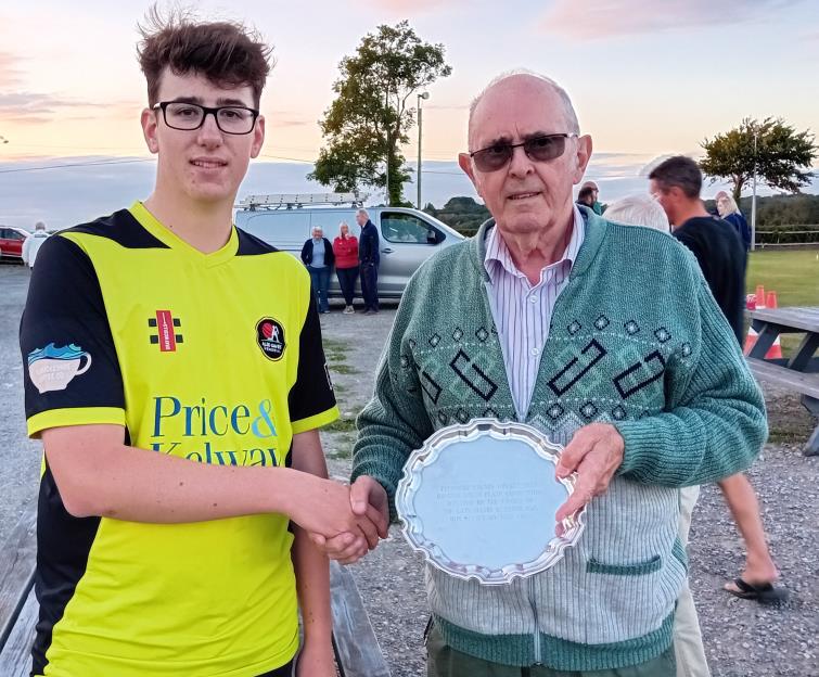 Oscar Lewis collects the winners trophy from Phil Lloyd